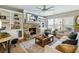 Comfortable living room with built-in shelving surrounding the fireplace and large windows that bring natural light at 6215 Barley Sq, Sugar Hill, GA 30518