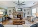 Inviting living room with a stone fireplace, custom built-ins, comfortable seating, and plenty of natural light at 6215 Barley Sq, Sugar Hill, GA 30518
