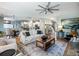 Spacious open-concept living room with hardwood floors, a fireplace, and seamless flow to the dining area and kitchen at 6215 Barley Sq, Sugar Hill, GA 30518