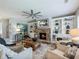 Inviting living room featuring a stone fireplace with built-in bookshelves, providing a cozy and stylish space at 6215 Barley Sq, Sugar Hill, GA 30518