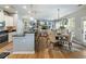 Open concept living space featuring kitchen, dining area, and living room with fireplace at 6215 Barley Sq, Sugar Hill, GA 30518