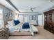 Primary bedroom showcasing a king bed, armoire, and ensuite bath at 6215 Barley Sq, Sugar Hill, GA 30518