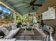 Well-appointed covered patio with comfortable seating, decorative plants, and a view of the beautifully landscaped backyard at 6215 Barley Sq, Sugar Hill, GA 30518