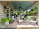 Inviting covered patio with comfortable seating, a ceiling fan, and a view of the well-maintained backyard at 6215 Barley Sq, Sugar Hill, GA 30518