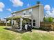 Backyard patio with an outdoor kitchen, cozy seating, and charming string lights, ideal for relaxing at 6215 Barley Sq, Sugar Hill, GA 30518