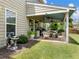 Charming covered patio with cozy seating, a ceiling fan, and decorative plants, creating a relaxing outdoor space at 6215 Barley Sq, Sugar Hill, GA 30518