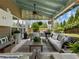 Relaxing covered patio with plush seating, stylish decor, and a view of the expansive, fenced backyard at 6215 Barley Sq, Sugar Hill, GA 30518