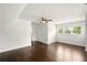 A spacious bedroom with hardwood floors, a ceiling fan, and three windows at 77 Township Drive, Hiram, GA 30141