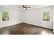 Bedroom features wood floors, two windows offering plenty of natural light and a ceiling fan at 77 Township Drive, Hiram, GA 30141