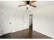 Comfortable bedroom featuring hardwood floors, ceiling fan, and ample closet space at 77 Township Drive, Hiram, GA 30141