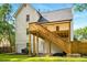 A two-story house featuring a wooden porch with stairs and a well-maintained lawn at 77 Township Drive, Hiram, GA 30141