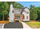 Beautiful home with a gray roof, white siding, and professionally landscaped front yard at 77 Township Drive, Hiram, GA 30141