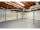 Spacious garage with exposed wood ceiling and room for multiple vehicles at 77 Township Drive, Hiram, GA 30141