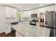 Well-lit kitchen with granite countertops, stainless appliances, and ample cabinet space at 77 Township Drive, Hiram, GA 30141