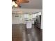 A modern kitchen with white cabinets, stainless steel appliances, and an island, open to the living area at 77 Township Drive, Hiram, GA 30141