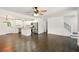 Open-concept living space showcases hardwood floors, modern lighting, and seamless flow to kitchen with island at 77 Township Drive, Hiram, GA 30141