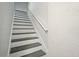Carpeted staircase with white walls and a white handrail at 77 Township Drive, Hiram, GA 30141