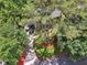 Aerial view of a beautiful home surrounded by lush trees and a well-manicured lawn at 2030 Spring End Ct, Lawrenceville, GA 30044