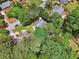 An aerial view of a home surrounded by lush trees in a residential neighborhood at 2030 Spring End Ct, Lawrenceville, GA 30044