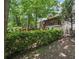 Lush backyard with mature trees and wooden staircase leading to an upstairs porch at 2030 Spring End Ct, Lawrenceville, GA 30044