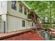 Backyard featuring a wooden deck, staircase, stream, and water fountain at 2030 Spring End Ct, Lawrenceville, GA 30044