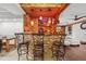 Custom bar area with stone accents, wood beams, pendant lighting, and barstool seating at 2030 Spring End Ct, Lawrenceville, GA 30044
