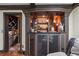 Basement bar area with wine storage, bar with granite counter, and ample lighting at 2030 Spring End Ct, Lawrenceville, GA 30044
