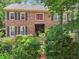 Charming two-story brick home with black shutters and lush landscaping at 2030 Spring End Ct, Lawrenceville, GA 30044