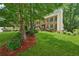 Well-maintained two-story home with lush front lawn and mature trees at 2030 Spring End Ct, Lawrenceville, GA 30044