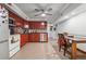 Bright kitchen with red cabinets, stainless appliances, and a dining area with tiled floors at 2030 Spring End Ct, Lawrenceville, GA 30044