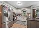 Efficient kitchen featuring white cabinets, stainless steel appliances, and granite countertops at 2030 Spring End Ct, Lawrenceville, GA 30044