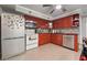 Well-equipped kitchen with red cabinets, mosaic backsplash, and stainless steel appliances at 2030 Spring End Ct, Lawrenceville, GA 30044