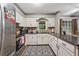 Well-lit kitchen with white cabinets and stainless appliances at 2030 Spring End Ct, Lawrenceville, GA 30044