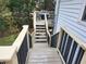 A back deck with black railings and a BBQ grill, accessed by descending stairs at 2811 Country Farms Ct, Snellville, GA 30039