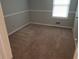 A bedroom with carpeted floors, neutral paint, and natural light from a window at 2811 Country Farms Ct, Snellville, GA 30039