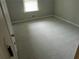 A bedroom featuring neutral walls, carpet, a window, and base trim at 2811 Country Farms Ct, Snellville, GA 30039