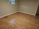 Bedroom featuring hardwood floors and light neutral walls with a window at 2811 Country Farms Ct, Snellville, GA 30039