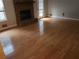 Spacious living room featuring a brick fireplace and hardwood flooring at 2811 Country Farms Ct, Snellville, GA 30039