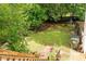 Overhead shot from wooden deck looking into a large, fenced backyard with a swing set at 68 Paradise Pointe, Douglasville, GA 30134
