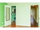 View of the bedroom featuring an open closet with mirror door and hardwood flooring at 68 Paradise Pointe, Douglasville, GA 30134
