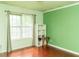 This bedroom features a light green color scheme, hardwood flooring, and bright, natural light at 68 Paradise Pointe, Douglasville, GA 30134