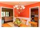 Traditional dining room with wooden table, chandelier, and bright orange walls at 68 Paradise Pointe, Douglasville, GA 30134