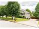 This home features a spacious lawn, a long driveway, and a three-car garage at 68 Paradise Pointe, Douglasville, GA 30134