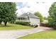 This home features a spacious lawn, a long driveway, and a three-car garage at 68 Paradise Pointe, Douglasville, GA 30134