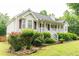 Charming home featuring a welcoming front porch and beautifully landscaped front yard with lush greenery at 68 Paradise Pointe, Douglasville, GA 30134