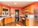 Bright eat-in kitchen featuring stainless appliances, wood cabinets, and tiled backsplash at 68 Paradise Pointe, Douglasville, GA 30134