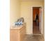 A mudroom features a cabinet with water bottles, and an open doorway to another room at 68 Paradise Pointe, Douglasville, GA 30134