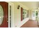 Inviting front porch with classic details and a beautiful entry door at 68 Paradise Pointe, Douglasville, GA 30134