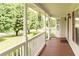 Inviting front porch with wood flooring, perfect for relaxing outdoors at 68 Paradise Pointe, Douglasville, GA 30134