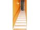 A stairwell with wood handrail leads to an upper level of this home at 68 Paradise Pointe, Douglasville, GA 30134